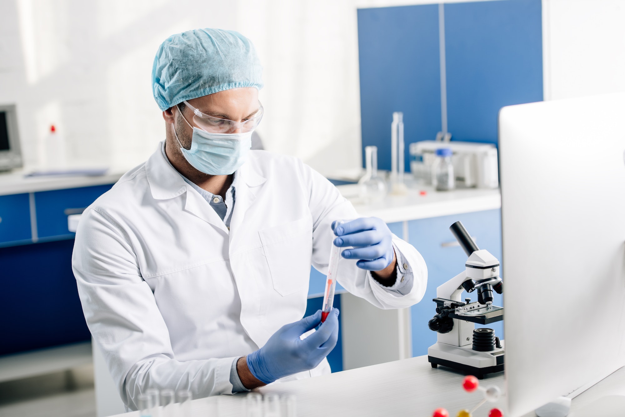 genetic consultant in white coat doing dna test in lab