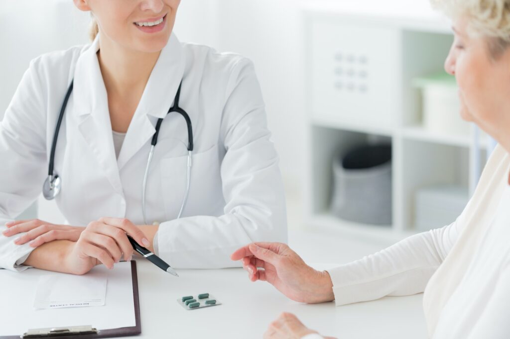 Doctor prescribing medication to patient